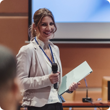 A woman giving a lecture holding a microphone