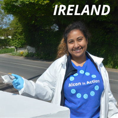 A female Alcon volunteer in Ireland picking up litter from streets