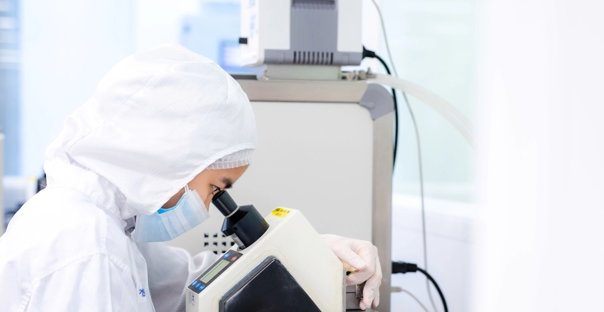 scientist using microscope in lab