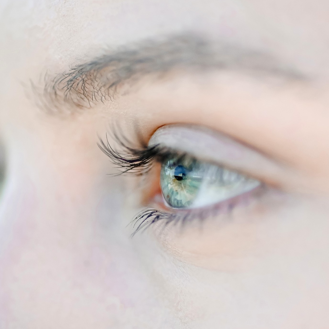 A close-up of a woman's eye looking to the left.