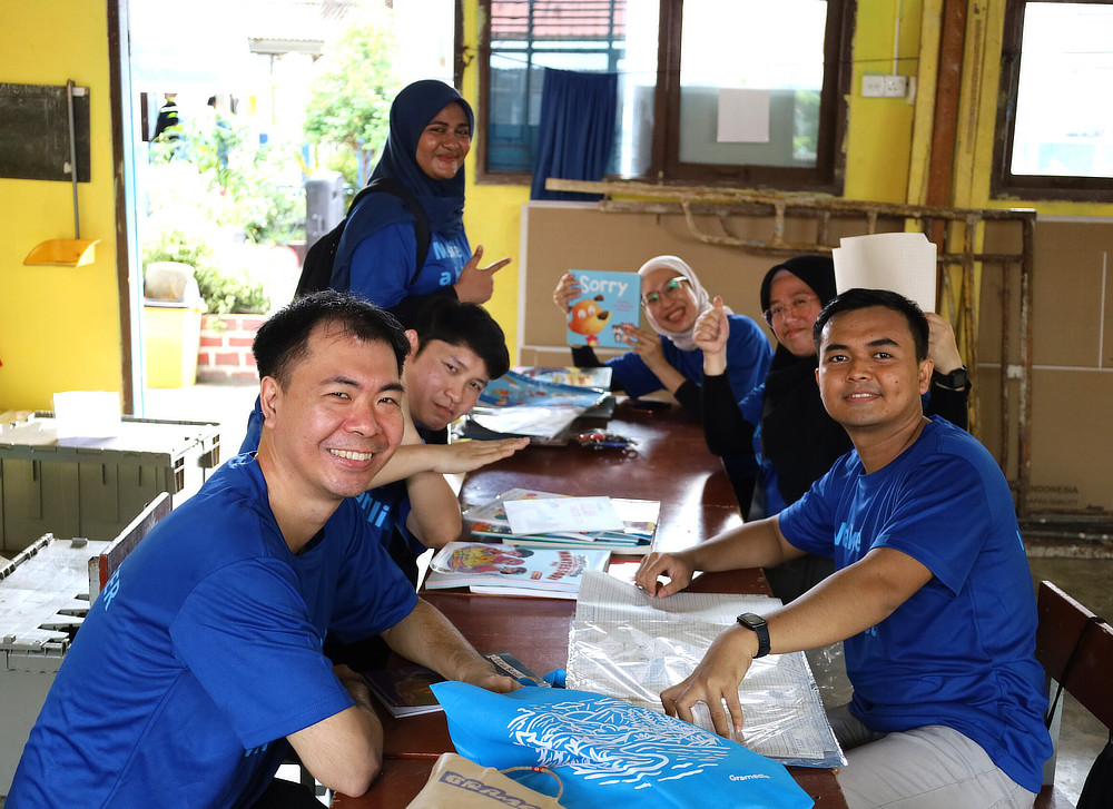 Employeesat a table with children's books