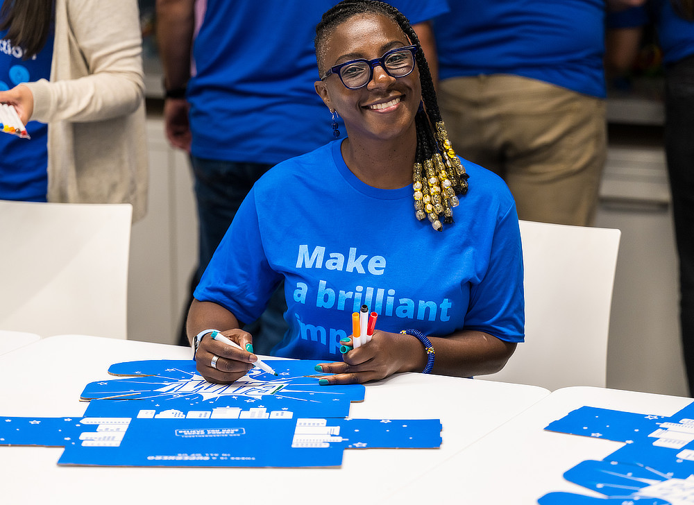 Employees filling out packing boxes
