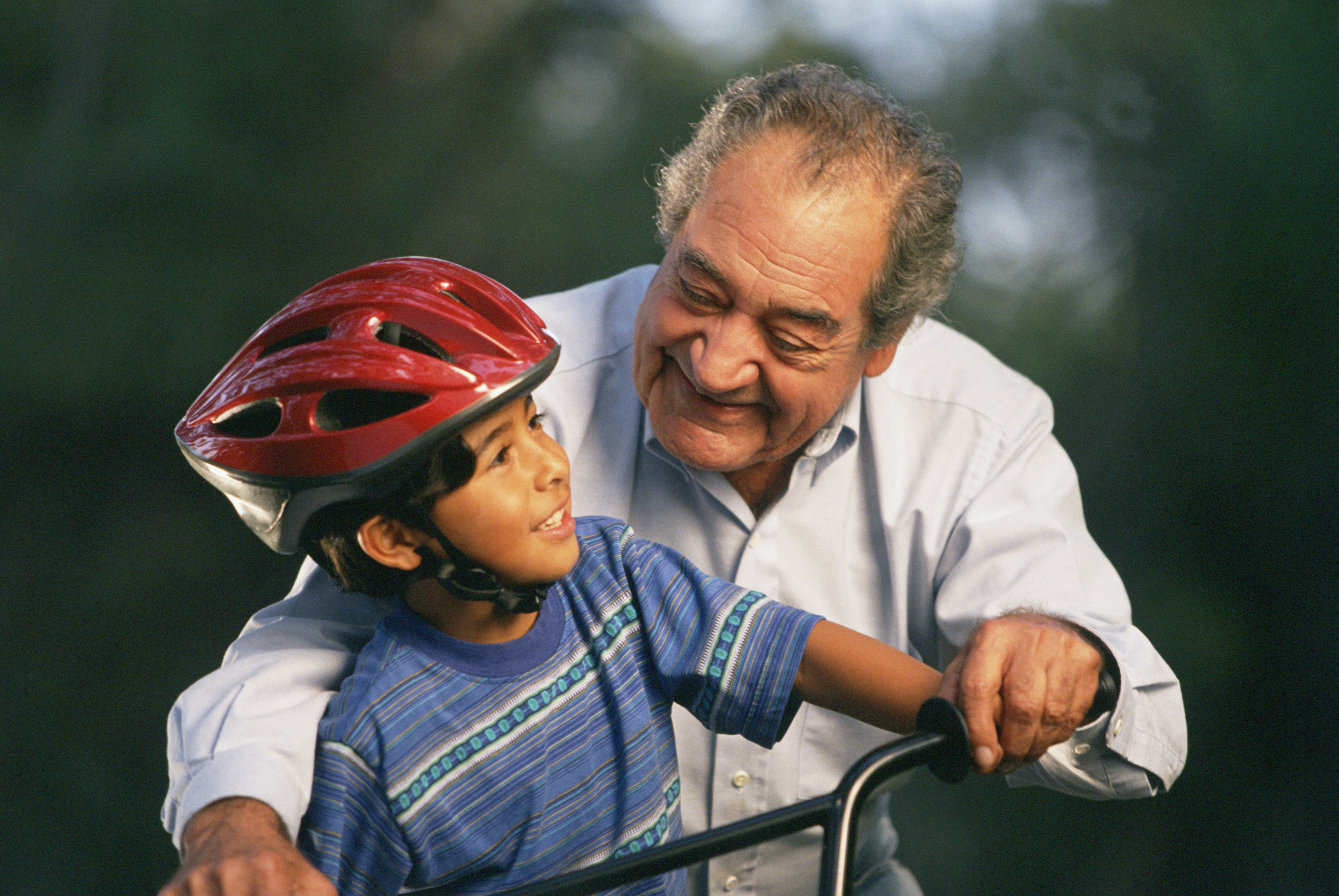 Older man with child on bicycle