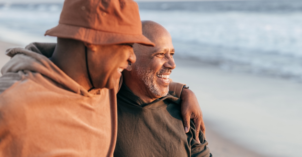 Two men sharing a laugh on beach